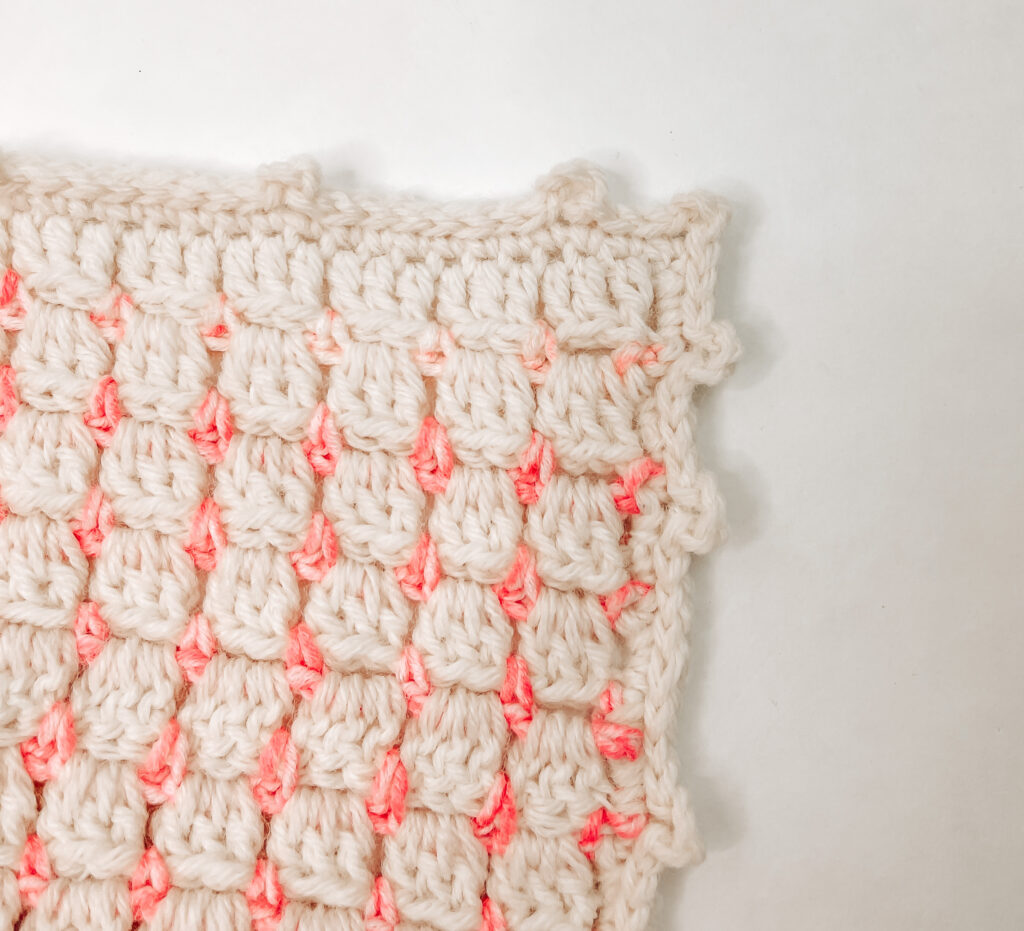 An image of a corner crochet blanket showing the block stitch.